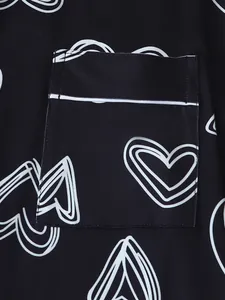 Detailed close-up showing heart pattern print and pocket on black loungewear fabric