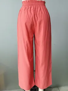 Back view of coral pink high-waisted elastic casual straight pants on mannequin.