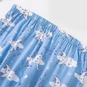 Detail van de blauwe katoenen pyjamabroek met maan en sterrenhemel print