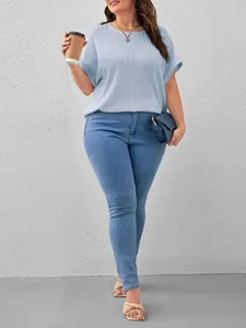 Elegant plus size light blue textured short sleeve T-shirt styled with casual denim jeans