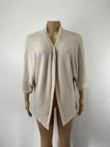 Gros plan d'un cardigan en maille gaufrée beige sur un mannequin montrant la texture