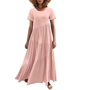 Model wearing pink asymmetrical tiered maxi dress with short sleeves and round neck