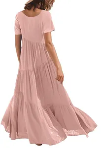 Back view of a loose pink tiered maxi dress with short sleeves and asymmetric hem