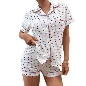 Women's white cotton pajama set with red heart print, button-down top and shorts.