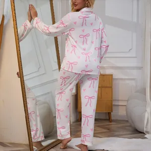 Women's two-piece pink bow and heart print pajama set with long sleeves and pants