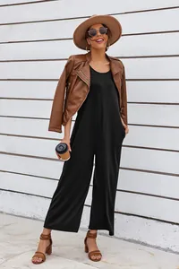 Chic black wide-leg jumpsuit styled with brown leather jacket and summer accessories
