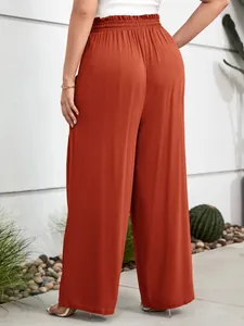 Rear detail of rust orange wide-leg casual pants featuring elastic high waist design