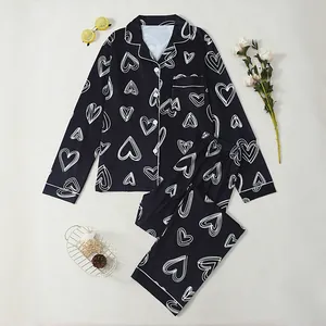 Elegant black long-sleeved pajama set with white heart prints and lapel collar for women