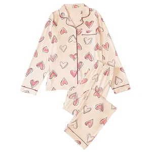 Soft women's two-piece heart print pajama set with long sleeves and lapel collar
