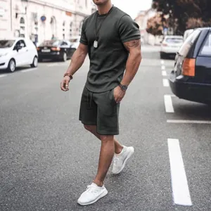 Modern dark grey men's summer t-shirt and shorts leisure set shown in urban street scene