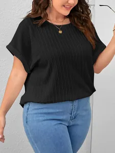 Macro view of the elegant black textured plus-size short-sleeve T-shirt on a model
