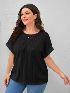 Close-up detail of a women's plus size black ribbed short-sleeved T-shirt on a model