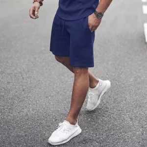 Detailed view of men's navy blue summer sports shorts featuring a functional drawstring waist