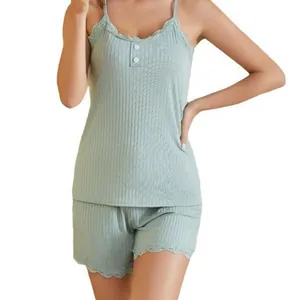 Detail of women's ribbed sage green camisole and shorts pajama set with lace trim.