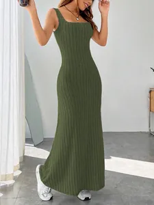 Detail view of a slim-fit olive green ribbed maxi dress on a model in a bright room