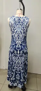 Back view of a blue and white ornamental print sleeveless maxi dress on a mannequin