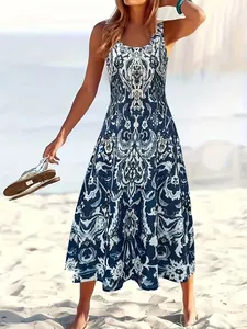 Detail view of a stylish blue and white bohemian printed sleeveless dress on a beach