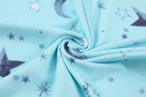 Close-up of soft light blue fabric with star and moon prints for women's homewear set