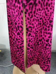 Detail view of fashionable pink leopard print high waist skirt featuring a sexy side slit