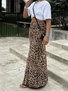 Street style view of a high-waisted leopard print maxi skirt for summer fashion.