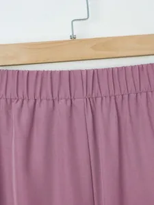 Detailed macro shot of an elastic waistband on comfortable purple casual trousers