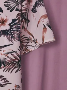Close-up of tropical floral print on short-sleeve top with soft mauve fabric detail