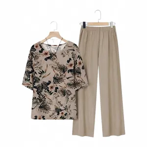 Two-piece casual set with floral printed short sleeve top and khaki wide-leg trousers.