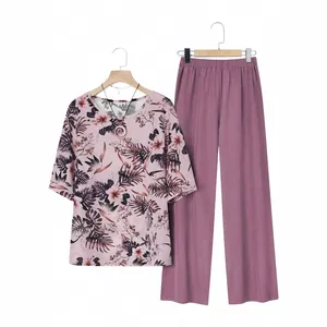 Women's two-piece set featuring floral short sleeve top and solid mauve wide-leg pants