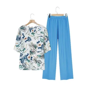 Two-piece women summer set with floral print short sleeve top and blue wide-leg trousers.