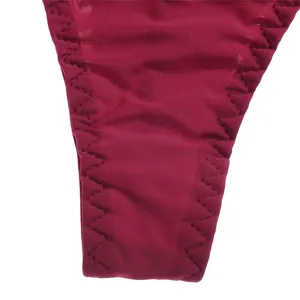 Macro detail of high-quality zig-zag stitching on burgundy seamless ice silk thong