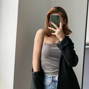Stylish woman wearing a grey seamless camisole with chest pads under a black blazer jacket