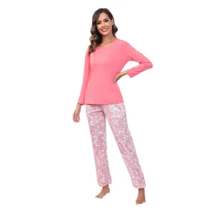 Ensemble pyjama femme avec haut rose uni à manches longues et pantalon à motif cachemire.