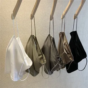 Seamless ribbed thin strap camisoles in multiple earthy tones displayed on wooden hangers.