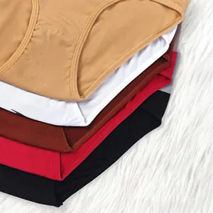 Detailed macro view of multi-colored breathable cotton panties for women stacked on white fur