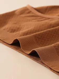 Detail shot showing the 3D honeycomb weave on brown seamless tummy control panties