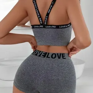 Premium grey two-piece sports bra and shorts set featuring stylish letter print bands
