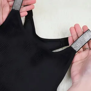 Détail du soutien-gorge de sport noir avec bretelles pailletées argentées et tissu côtelé