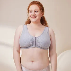 Front closure plus size gray cotton wireless bra shown on a smiling curvy model in studio