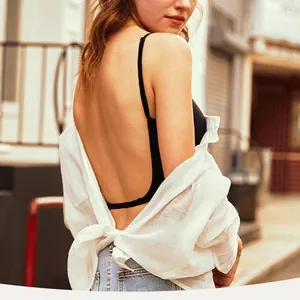 Rear view of a seamless backless U-shaped bra on a model showing the deep low back design