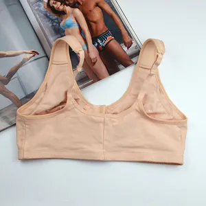 Detailed back view of a beige large size cotton wire-free bra placed on a white surface