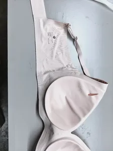 Interior detail of seamless beige bra with printed size label and laundry care icons