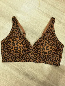 Seamless leopard print push-up bra with deep V-neck design on wooden background
