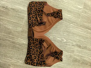 Macro view of seamless leopard print bra with deep V-neck and soft fabric texture
