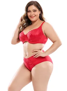 Detailed view of a red floral lace plus size lingerie set on a smiling model