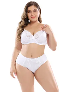 Front view of a white lace plus size lingerie set on a professional female model in a studio