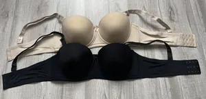 Detailed macro view of seamless plus size bras in smooth black and beige fabric finish
