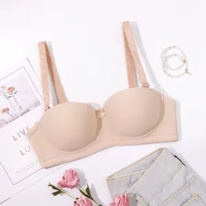 Elegant seamless nude half-cup strapless bra displayed in a stylish lifestyle flat lay