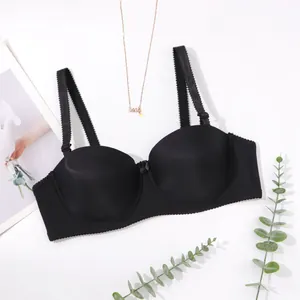 Detail view of a black seamless strapless bra with smooth fabric and decorative straps