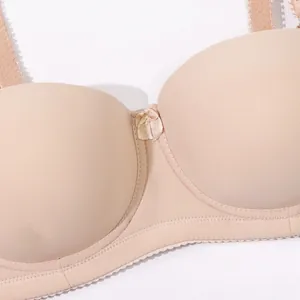 Close-up detail of a seamless nude smooth bra with half cup design and center bow decoration