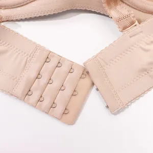 Macro detail shot showing the secure four-hook back closure of a seamless nude bra